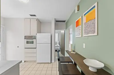 a kitchen with white cabinets and a white refrigerator at SUPER BOHO - Lake Toho Timeless Charm in Kissimmee