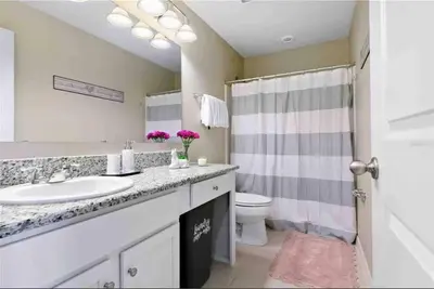 a bathroom with a sink and a toilet and a shower at SUPER CHIC - 4 Bedroom TOWNHOME IN DISNEY AREA in Kissimmee