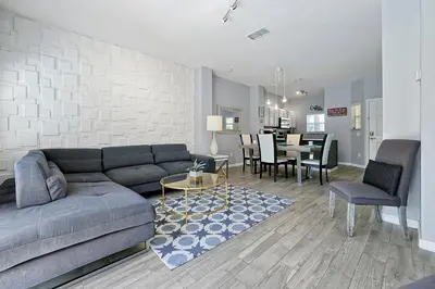 a living room with a couch and a dining room at Encantada Resort - Spacious 3-Bedroom Villa with Private Pool Near Disney in Kissimmee