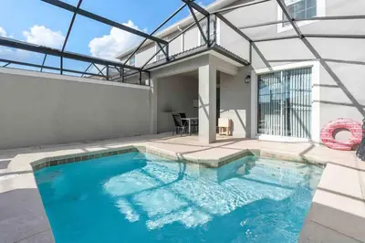 a swimming pool in the backyard of a house at SUPER DOPE- Home w POOL & AMENITIEs in Kissimmee