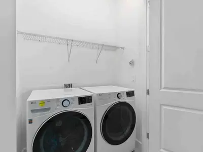 a white washing machine in a white laundry room at SUPER JUMBO - 12BD 12BAs SLEEPs 34 - w AMENITIEs in Kissimmee
