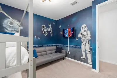 a bedroom with a mural of an astronaut on the wall at SUPER JUMBO - 12BD 12BAs SLEEPs 34 - w AMENITIEs in Kissimmee