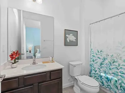 a bathroom with a toilet and a sink and a shower curtain at Super Huge- 12BD 12BAs - Sleeps 38 in Kissimmee