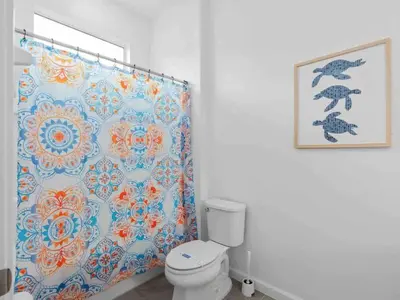 a bathroom with a toilet and a shower curtain at Super Huge- 12BD 12BAs - Sleeps 38 in Kissimmee