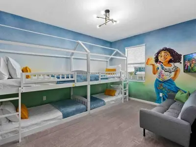 a room with two bunk beds and a painting of a girl at Super Huge- 12BD 12BAs - Sleeps 38 in Kissimmee