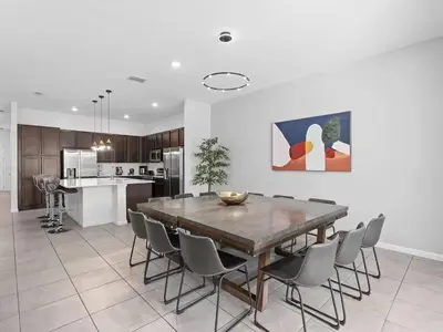 a kitchen and dining room with a table and chairs at Super Huge- 12BD 12BAs - Sleeps 38 in Kissimmee
