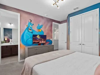 a bedroom with a bed with a painting on the wall at Super Huge- 12BD 12BAs - Sleeps 38 in Kissimmee
