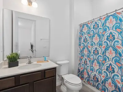 a bathroom with a toilet and a shower curtain at SUPER SPACE - 12BD 12BA - MANY ENSUITEs SLEEPs 38 in Kissimmee