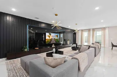 a living room with couches and a flat screen tv at SUPER FANCY- 15BDR 17BAs HUGE 7 000SQFT HOME in Kissimmee