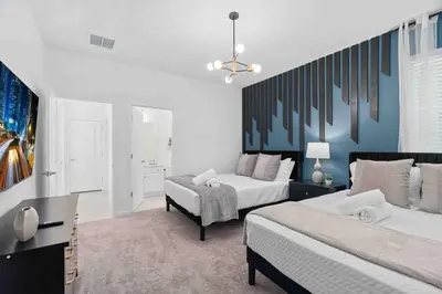 a bedroom with two beds and a couch in it at SUPER FANCY- 15BDR 17BAs HUGE 7 000SQFT HOME in Kissimmee
