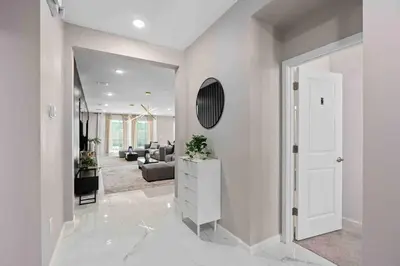 a white hallway with a living room with a mirror at SUPER FANCY- 15BDR 17BAs HUGE 7 000SQFT HOME in Kissimmee