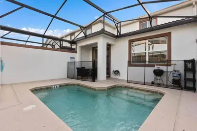 a swimming pool in the middle of a house at Super Chill - 5 Bedrooms WPOOls in Kissimmee
