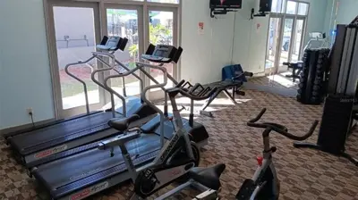 a gym with three exercise bikes in a room at Two bed condo in Parkway Palms Resort condo in Orlando
