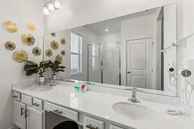 a bathroom with two sinks and a large mirror at 295 Marcello Blvd in Kissimmee