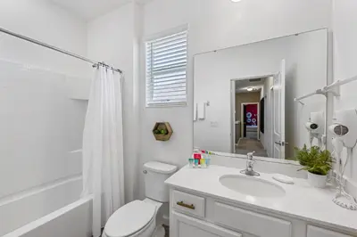 a white bathroom with a toilet and a sink at 295 Marcello Blvd in Kissimmee