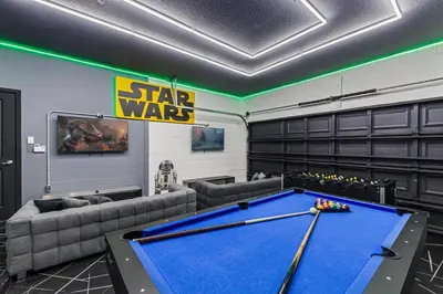 a pool table in a room with a star wars sign at 295 Marcello Blvd in Kissimmee