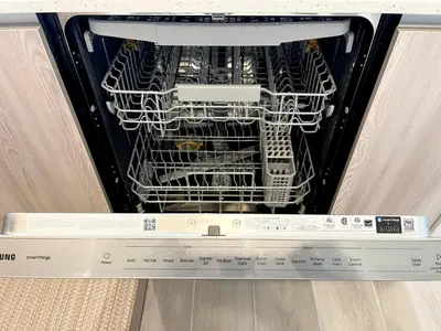 a dishwasher with racks of dishes in it at Serenity Townhome Getaway 4 bed 3 bath home near Disney in Clermont FL in Orlando