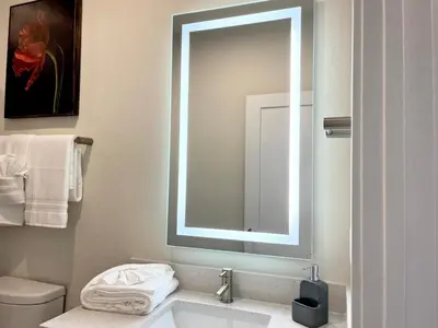 a white bathroom with a sink and a mirror at Serenity Townhome Getaway 4 bed 3 bath home near Disney in Clermont FL in Orlando