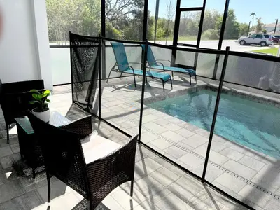 a balcony with chairs and a swimming pool at Serenity Townhome Getaway 4 bed 3 bath home near Disney in Clermont FL in Orlando