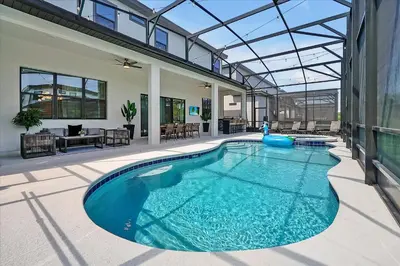 a swimming pool in a house with a glass ceiling at Gorgeous Paradiso Mansion Pool-Game-Room-Theater-3 in Orlando