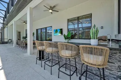 a dining area with chairs and a bar in a house at Gorgeous Paradiso Mansion Pool-Game-Room-Theater-3 in Orlando
