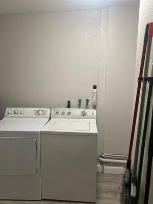 a white washer and dryer in a room at City and Stadium Sanctuary Vibes in Orlando
