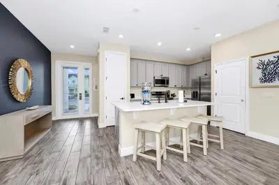 a kitchen with a large island with stools at Comfy Villa Near Disney With Margaritaville Resort & Island H20 Access - 8155Cp in Orlando