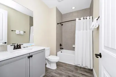 a white bathroom with a toilet and a sink at Comfy Villa Near Disney With Margaritaville Resort & Island H20 Access - 8155Cp in Orlando