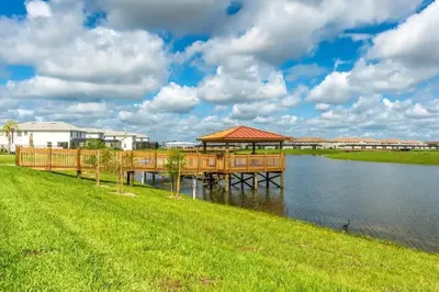 a dock with a gazebo on the water at Apartamento Moderno 2Q | Quarto Temático do Mickey in Kissimmee
