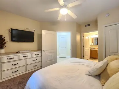a bedroom with a bed and a flat screen tv at Orlando 1st Floor - 5 min Disney in Orlando