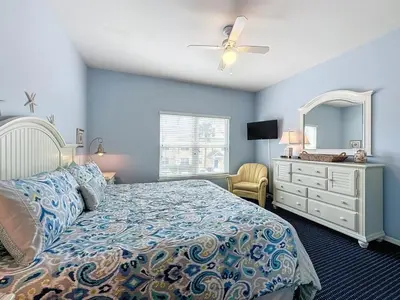 a bedroom with a bed and a dresser and a mirror at Two Bedroom Condo near Disney condo in Kissimmee