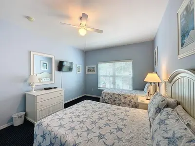 a bedroom with two beds and a couch at Two Bedroom Condo near Disney condo in Kissimmee