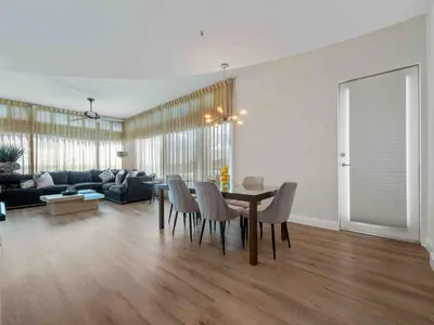 a living room with a table and chairs and a couch at PentHouse Downtown Orlando 2 Beds 2 baths in Orlando