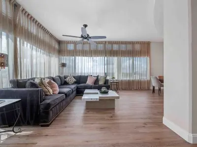 a living room with a couch and a ceiling fan at PentHouse Downtown Orlando 2 Beds 2 baths in Orlando