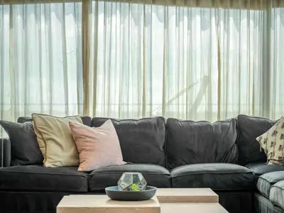 a black leather couch in a living room with a table at PentHouse Downtown Orlando 2 Beds 2 baths in Orlando