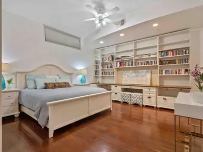 a bedroom with a large bed and book shelves at PentHouse Downtown Orlando 2 Beds 2 baths in Orlando