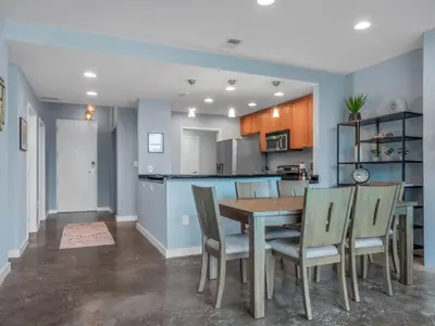 a kitchen and dining room with a table and chairs at Luxurious 2 Beds 2 Baths Downtown Apartment in Orlando