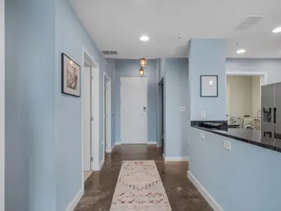 a hallway of a home with blue walls at Luxurious 2 Beds 2 Baths Downtown Apartment in Orlando
