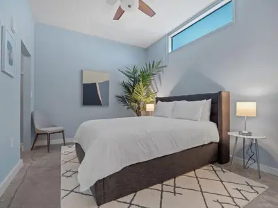a bedroom with a bed and a ceiling fan at Luxurious 2 Beds 2 Baths Downtown Apartment in Orlando
