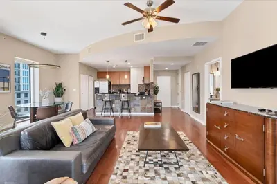 a living room with a couch and a flat screen tv at Beautiful Downtown Condo 1 Bed 1 Bath in Orlando