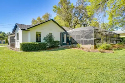 a house with a greenhouse in front of a yard at Near Parks and Lakes Sorrento Home with Pool and Yard! in Sorrento