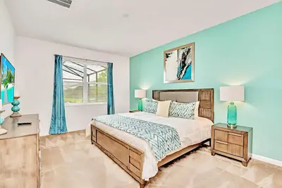 a bedroom with a bed and a window at Family Home with Cinema Pool and BBQ Near Disney in Kissimmee