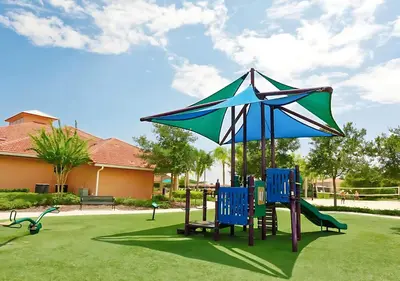 a playground with blue chairs and an umbrella at Family Home with Cinema Pool and BBQ Near Disney in Kissimmee