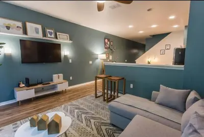 a living room with a couch and a flat screen tv at Magic Starts Here! Minutes to Disney Land in Orlando