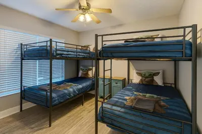 two bunk beds in a room with a ceiling fan at Disney-Area 4BR | Pool + Patio in Kissimmee