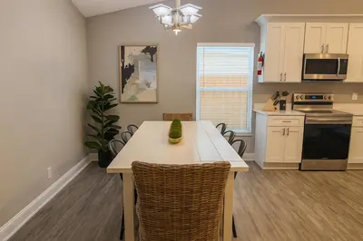 a kitchen with a table and chairs in a room at Disney-Area 4BR | Pool + Patio in Kissimmee