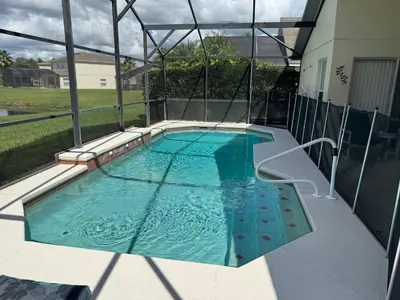 a swimming pool in the middle of a house at Sunset Villa – Your Gateway to a Magical Florida Vacation! in Kissimmee