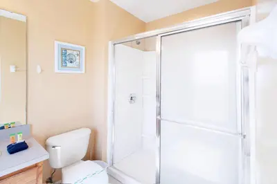 a bathroom with a shower and a white toilet at Flash 20 Off Amazing Pvt Pool Townhome in Kissimmee