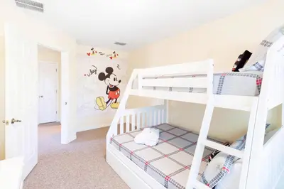 a bedroom with a bunk bed with a mickey mouse mural at Flash 20 Off Amazing Pvt Pool Townhome in Kissimmee