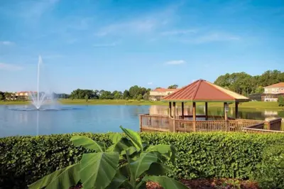 a gazebo next to a lake with a fountain at Flash 20 Off Amazing Pvt Pool Townhome in Kissimmee
